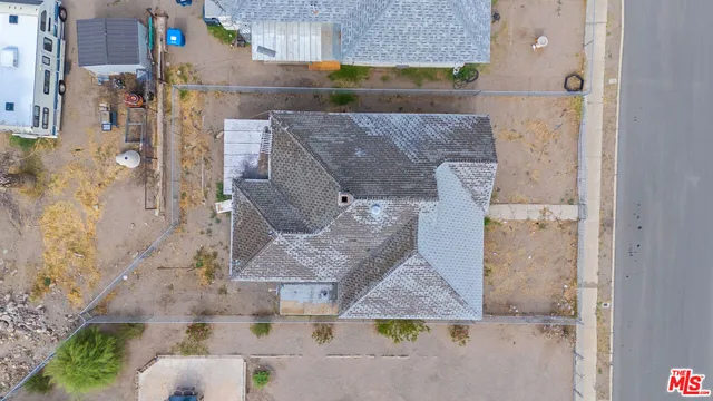 an aerial view of a city with lots of residential buildings ocean and mountain view in back