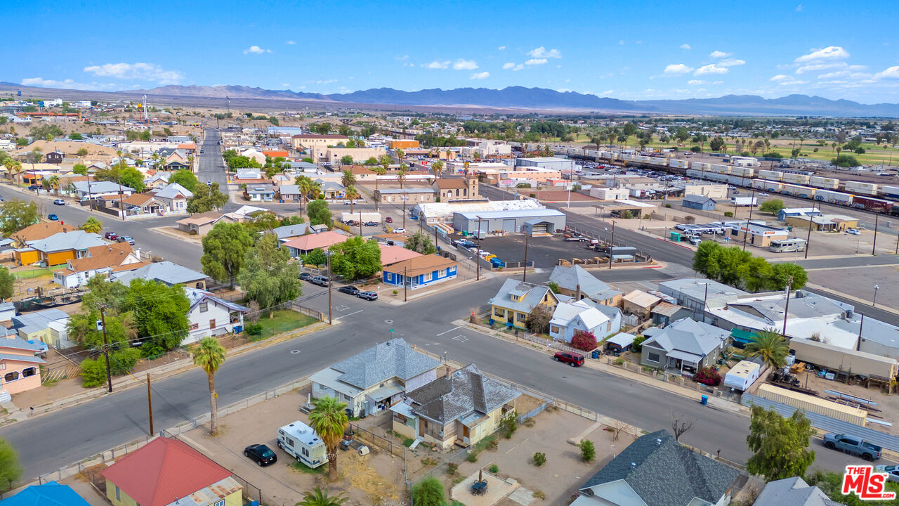 419 Acoma Street Needles, CA 92363 - Photo 12 of 29 an aerial view of a city with lots of residential buildings ocean and mountain view in back