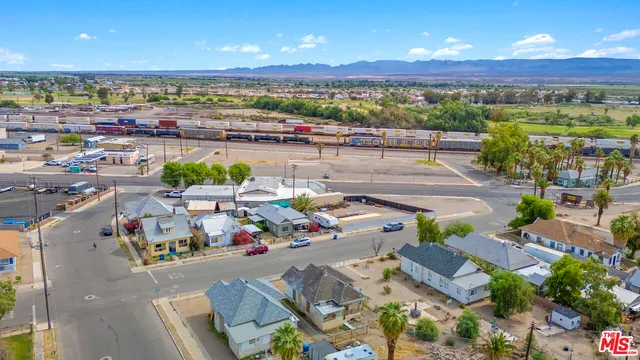 an aerial view of a house with a yard and sitting area
