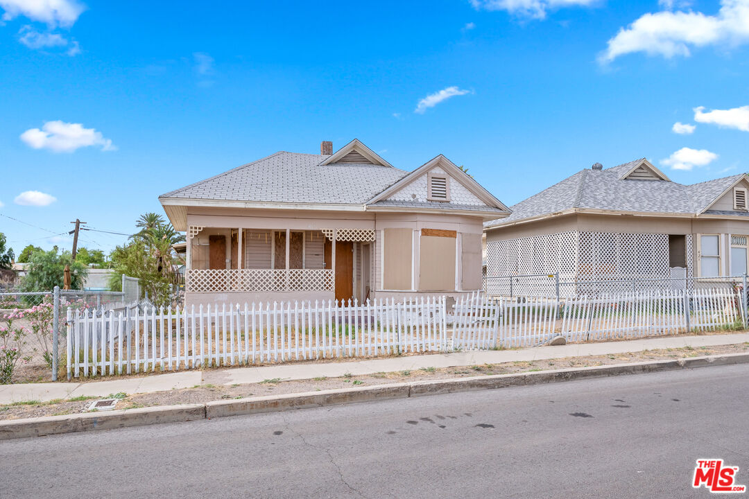 419 Acoma Street Needles, CA 92363 - Photo 16 of 29 a front view of a house with a garden