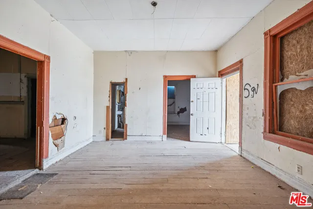 a view of empty room with white walls