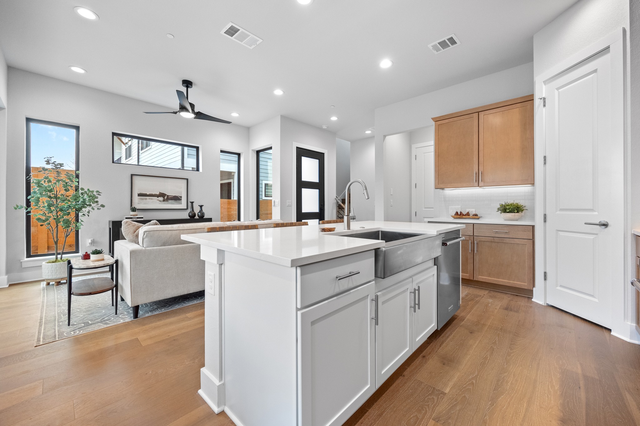 2707 Dulce Lane, Unit 14 Austin, TX 78704 - Photo 11 of 40 a large white kitchen with a stove a sink a refrigerator and white cabinets