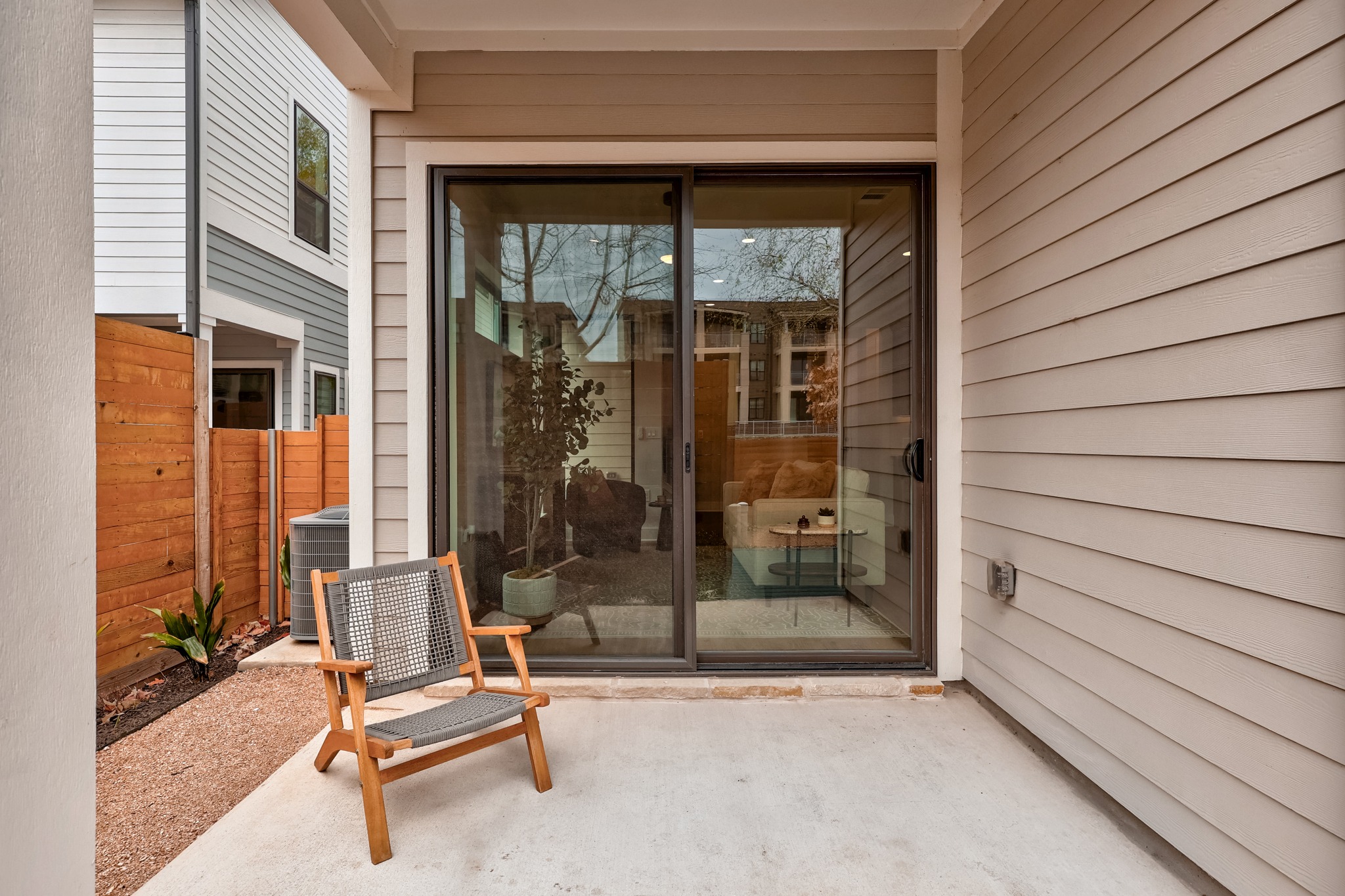 2707 Dulce Lane, Unit 14 Austin, TX 78704 - Photo 28 of 40 a view of backyard with a chair and floor to ceiling window