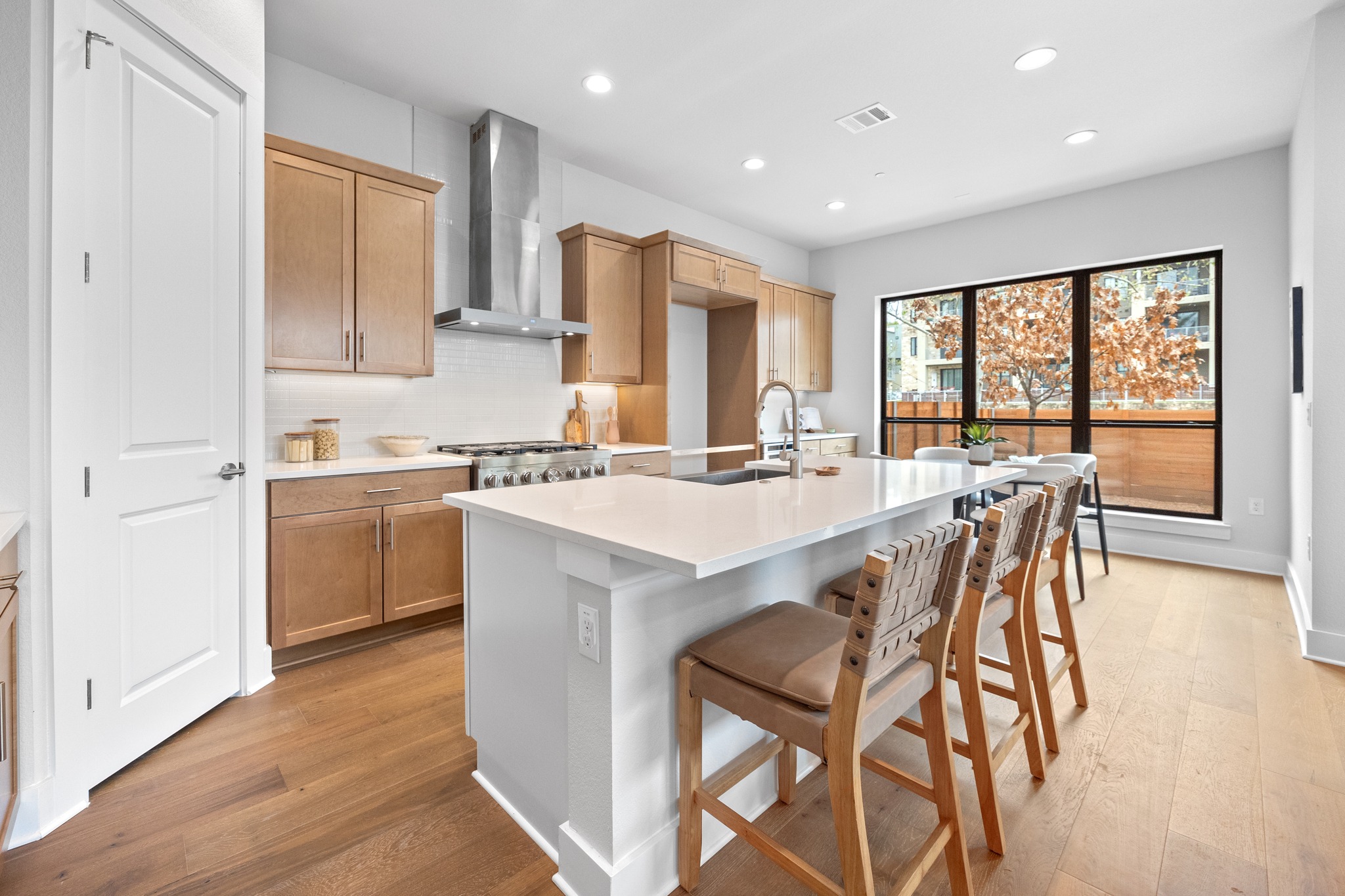 2707 Dulce Lane, Unit 14 Austin, TX 78704 - Photo 8 of 40 a kitchen with a stove a sink a dining table and chairs