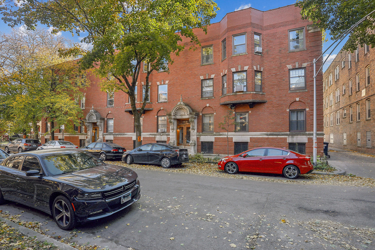 a car parked in front of a brick house