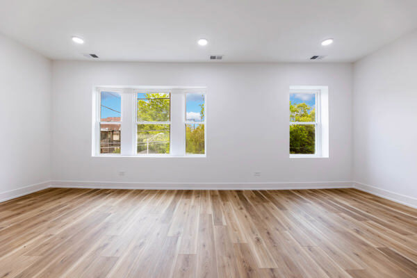 243 West 74th Street, Unit 2 Chicago, IL 60621 - Photo 8 of 12 an empty room with wooden floor and windows