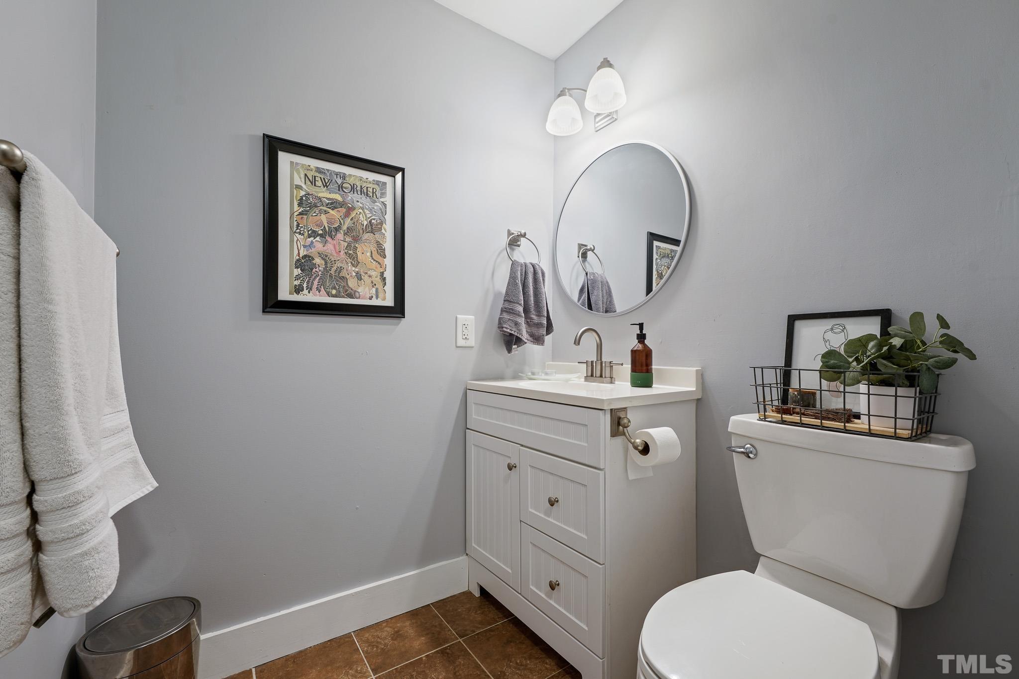 5218 Duraleigh Road Raleigh, NC 27612 - Photo 13 of 27 a bathroom with a toilet sink and mirror