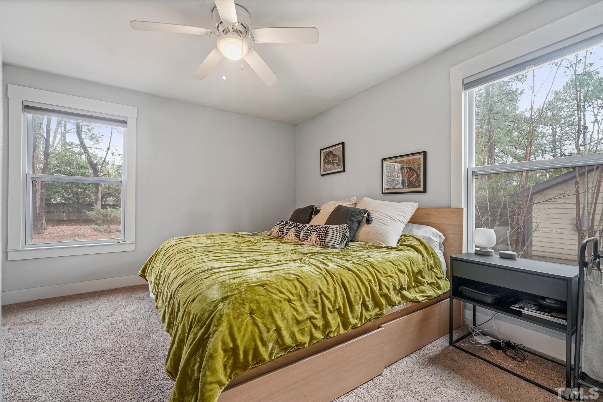5218 Duraleigh Road Raleigh, NC 27612 - Photo 14 of 27 a bed sitting in a bedroom next to a window