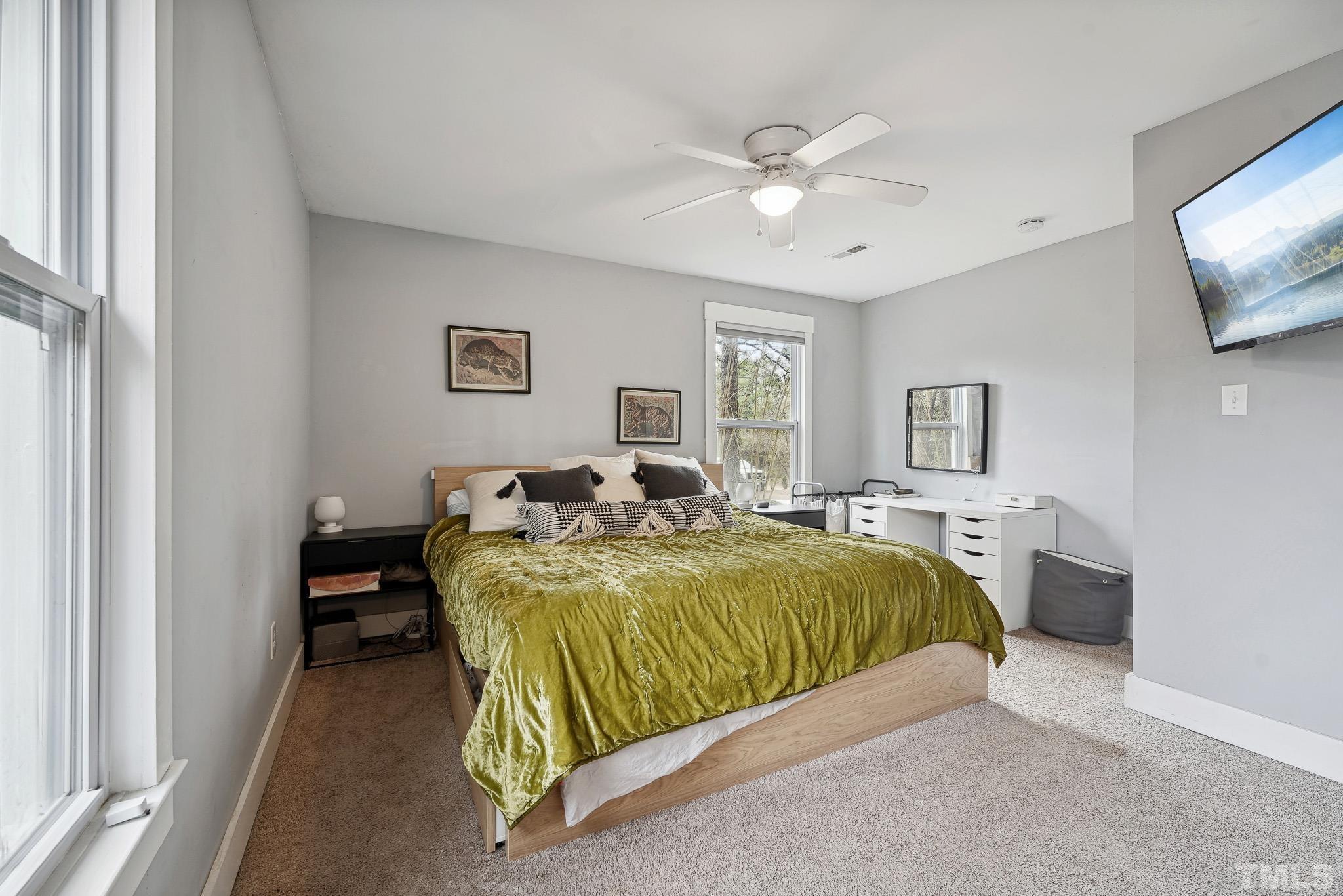 5218 Duraleigh Road Raleigh, NC 27612 - Photo 15 of 27 a bedroom with a bed and view of living room