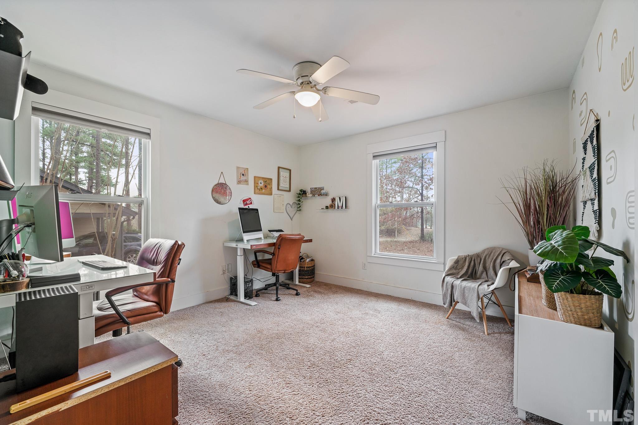 5218 Duraleigh Road Raleigh, NC 27612 - Photo 19 of 27 a living room with furniture and a potted plant