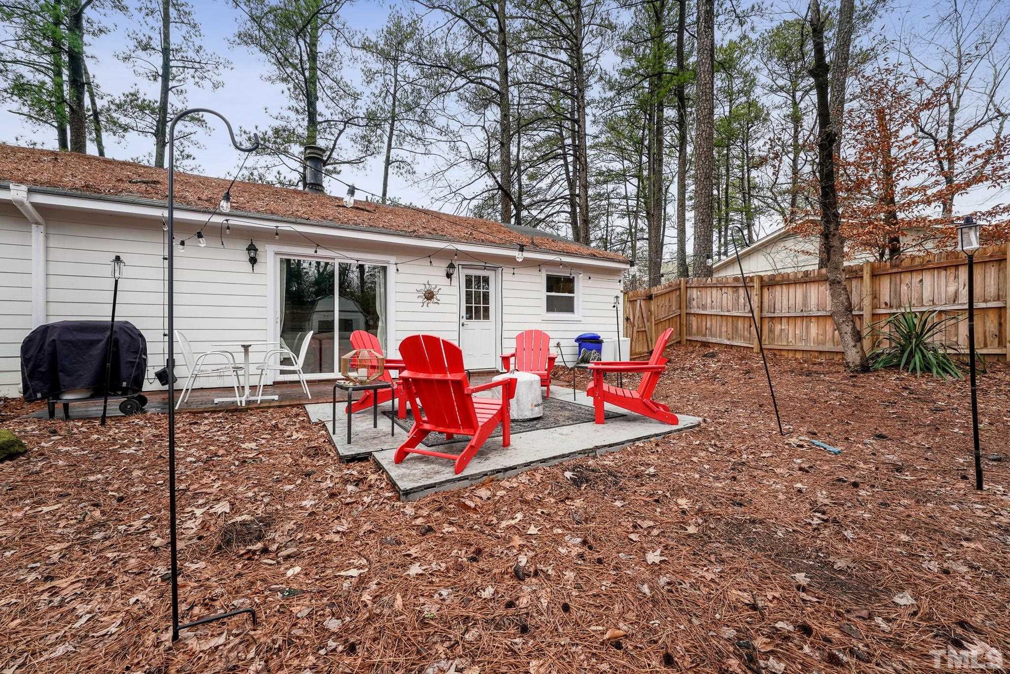 5218 Duraleigh Road Raleigh, NC 27612 - Photo 23 of 27 a view of a house with backyard and sitting area