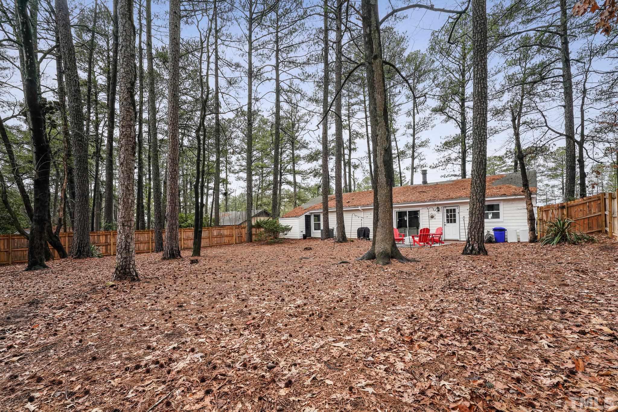 5218 Duraleigh Road Raleigh, NC 27612 - Photo 27 of 27 a house with trees in front of it