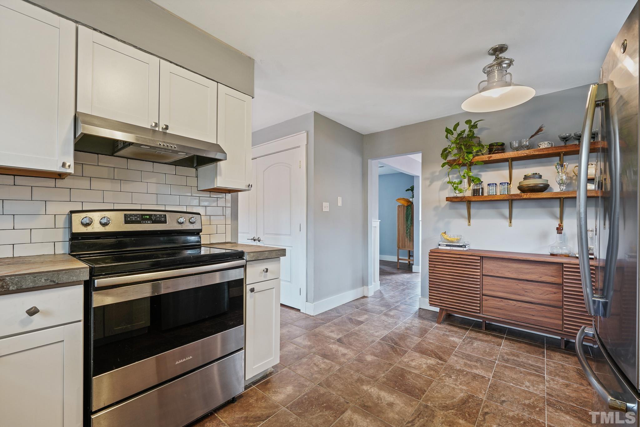 5218 Duraleigh Road Raleigh, NC 27612 - Photo 9 of 27 a kitchen with stainless steel appliances granite countertop a stove and a sink