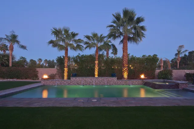 a view of a yard with a swimming pool