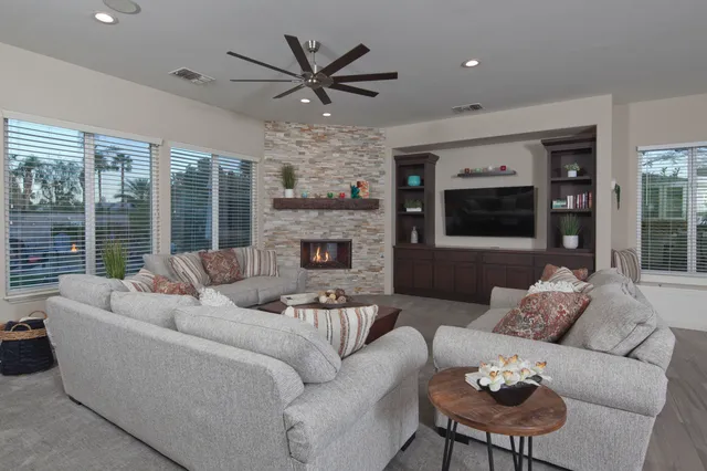 a dining room with stainless steel appliances a table chairs and a kitchen view