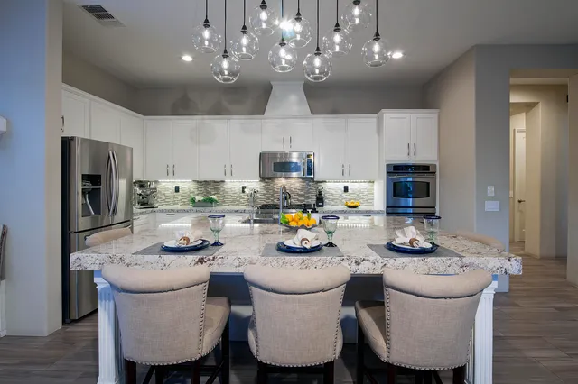 a stove top oven sitting inside of a kitchen