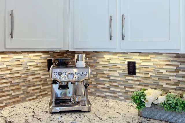 a front view of a house with a garden and patio