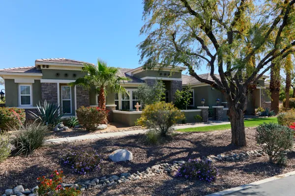 a view of a patio with chairs and potted plants
