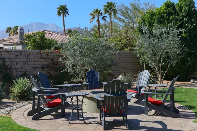 a swimming pool with outdoor seating and yard