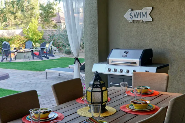 a palm tree sitting in a yard with a lake view
