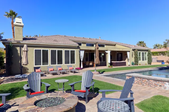 a bedroom with a bed television and a large window