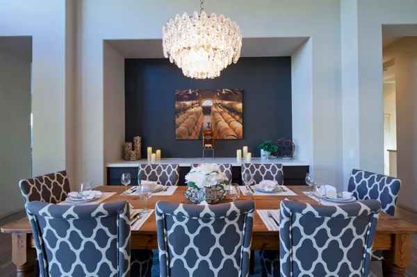 a balcony with furniture and chandelier