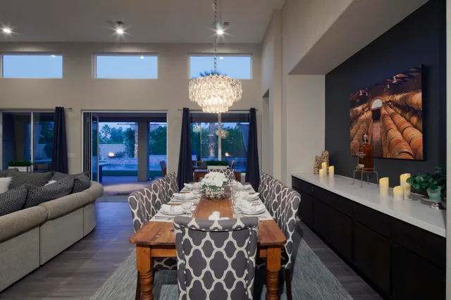a view of a dining room with furniture and chandelier