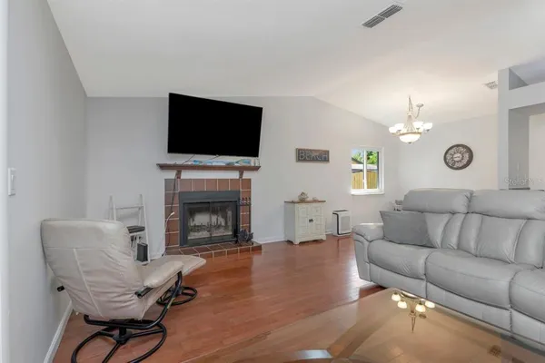 a living room with furniture a fireplace and a flat screen tv