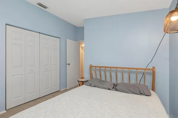 a bedroom with a bed and a large window