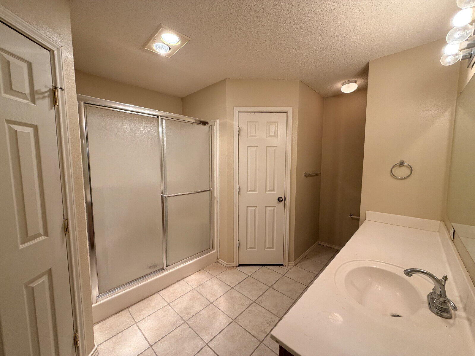 6126 16th Street Lubbock, TX 79416 - Photo 13 of 17 a bathroom with a tub and shower