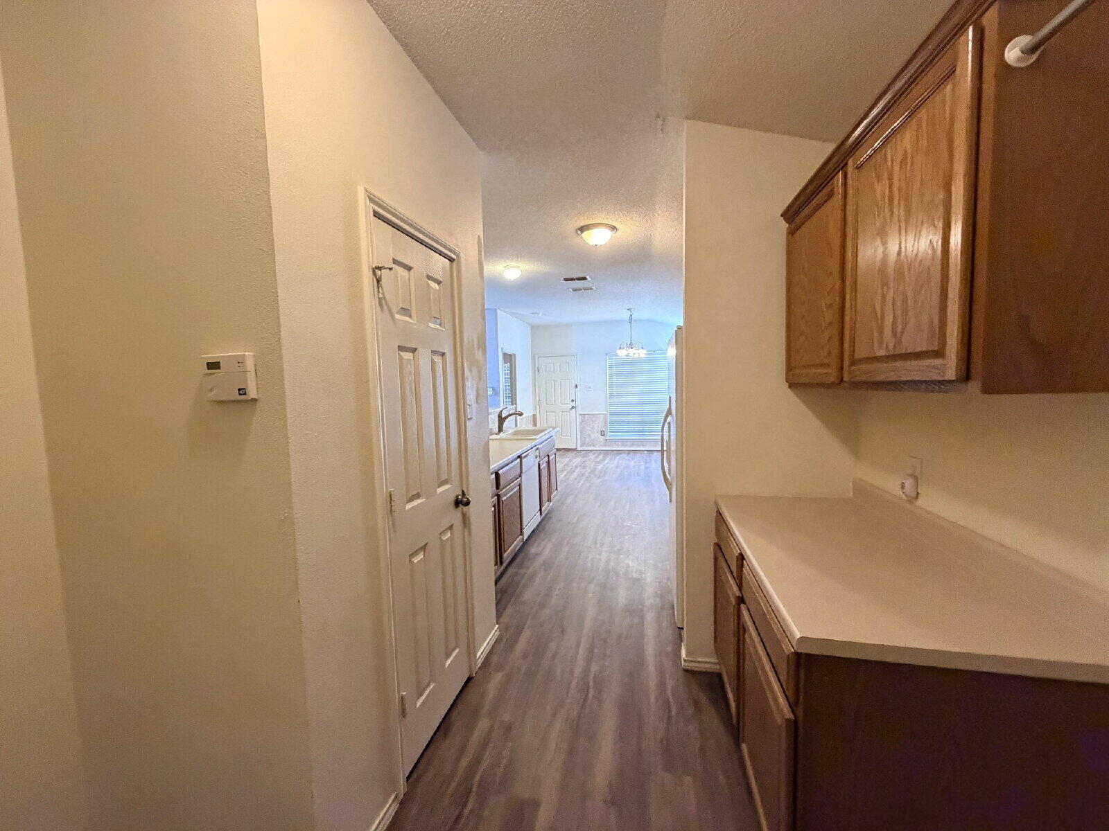 6126 16th Street Lubbock, TX 79416 - Photo 15 of 17 a view of a hallway with wooden floor and staircase