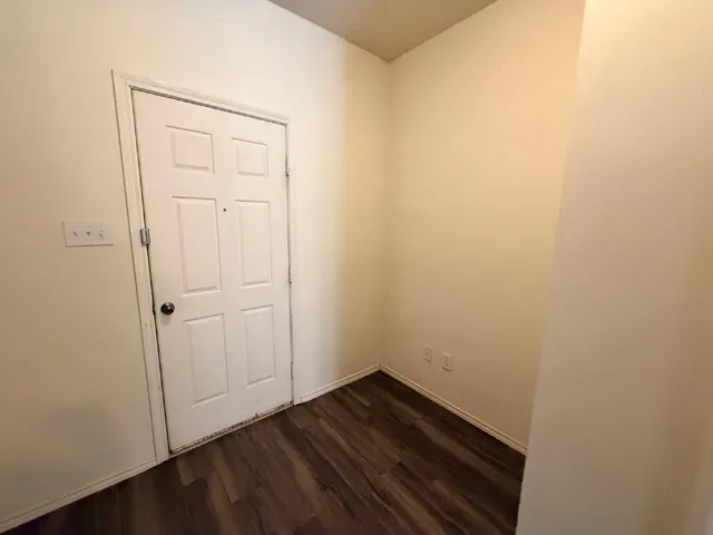 an empty room with wooden floor