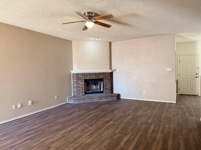 wooden floor in an empty room with a fireplace