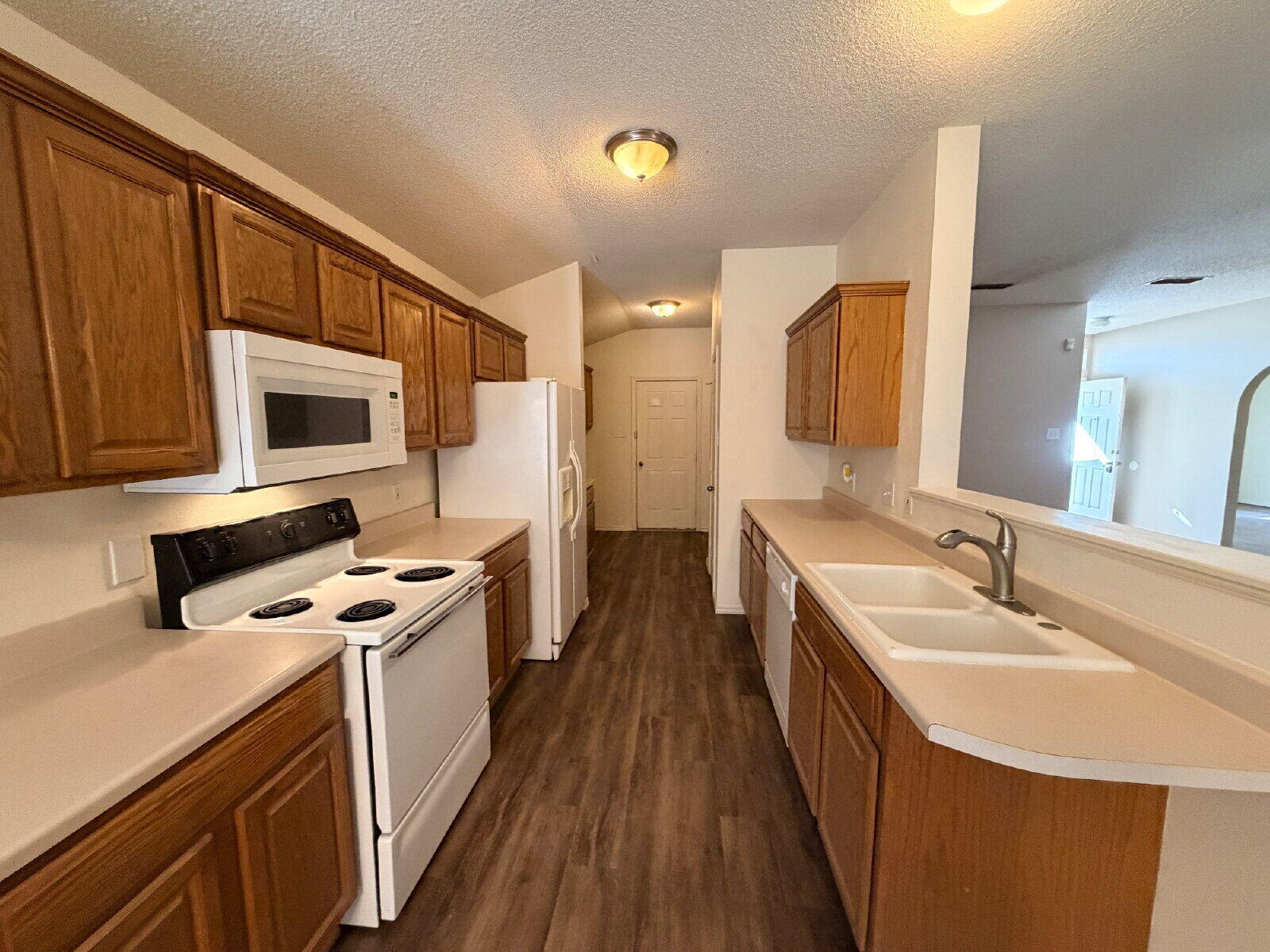 6126 16th Street Lubbock, TX 79416 - Photo 5 of 17 a kitchen with stainless steel appliances granite countertop a sink stove and refrigerator