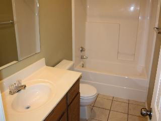 6126 16th Street Lubbock, TX 79416 - Photo 10 of 17 a bathroom with a sink a toilet and bathtub