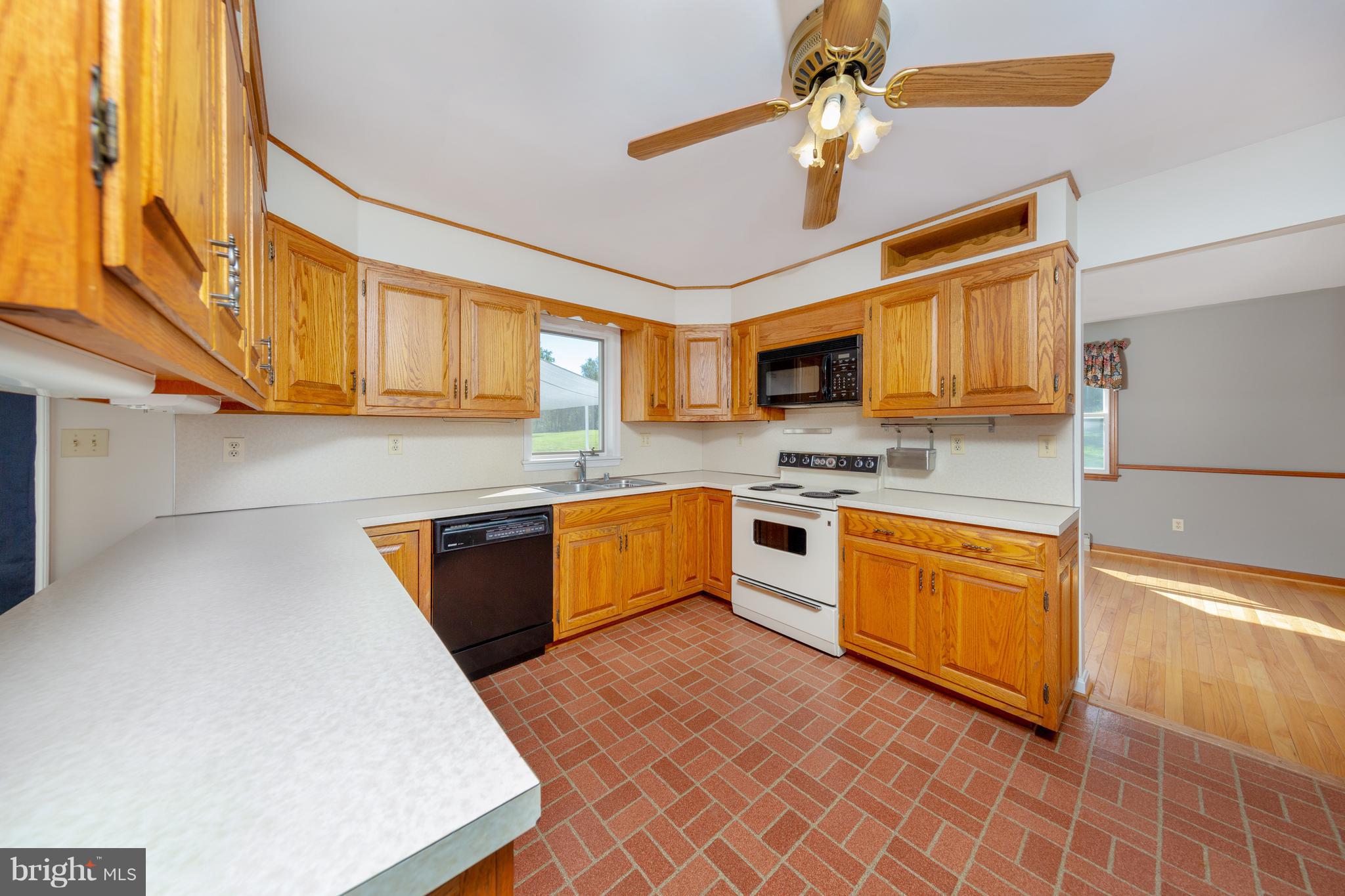 18257 Falls Road Hampstead, MD 21074 - Photo 2 of 49 a kitchen with stainless steel appliances granite countertop a sink a stove cabinets counter space and a window