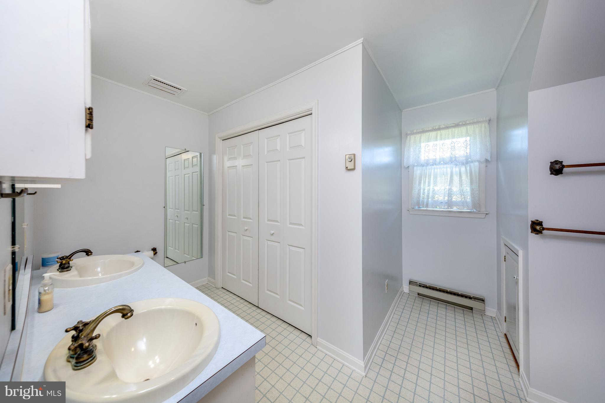 18257 Falls Road Hampstead, MD 21074 - Photo 18 of 49 a bathroom with a sink and a mirror