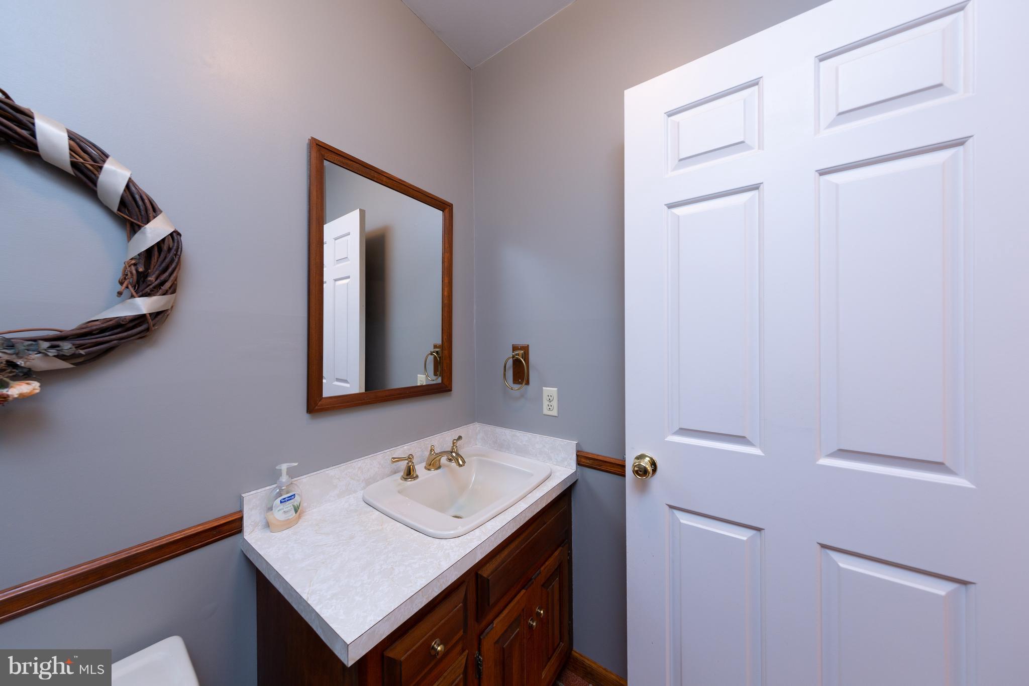 18257 Falls Road Hampstead, MD 21074 - Photo 20 of 49 a bathroom with a sink a vanity and a mirror