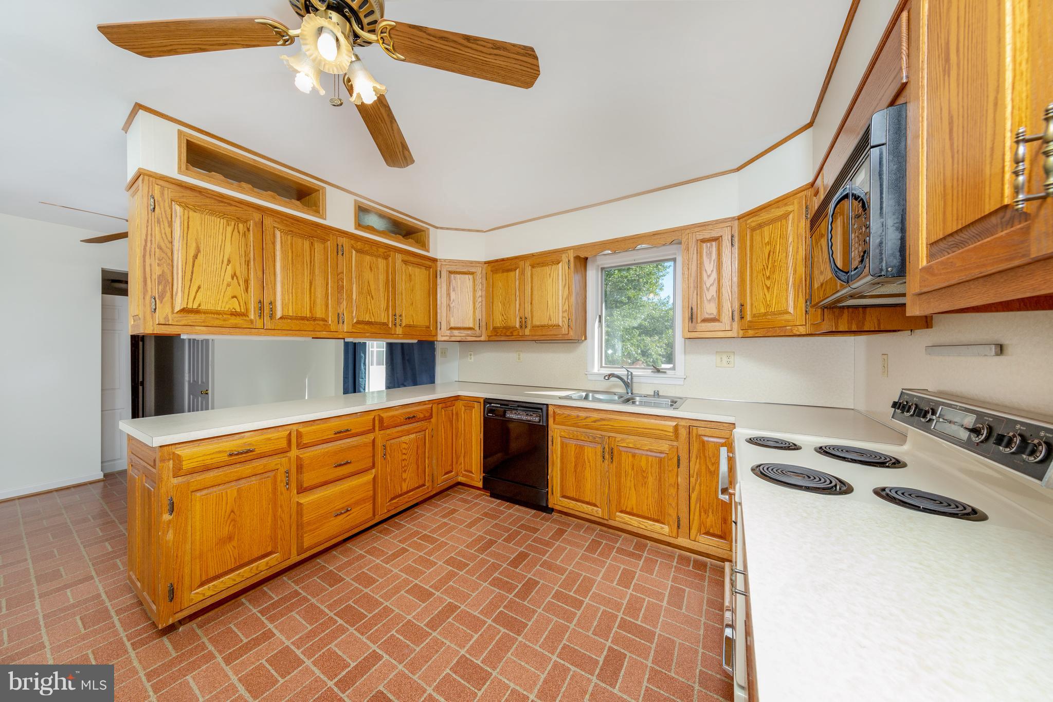 18257 Falls Road Hampstead, MD 21074 - Photo 3 of 49 a kitchen with stainless steel appliances granite countertop a sink and cabinets