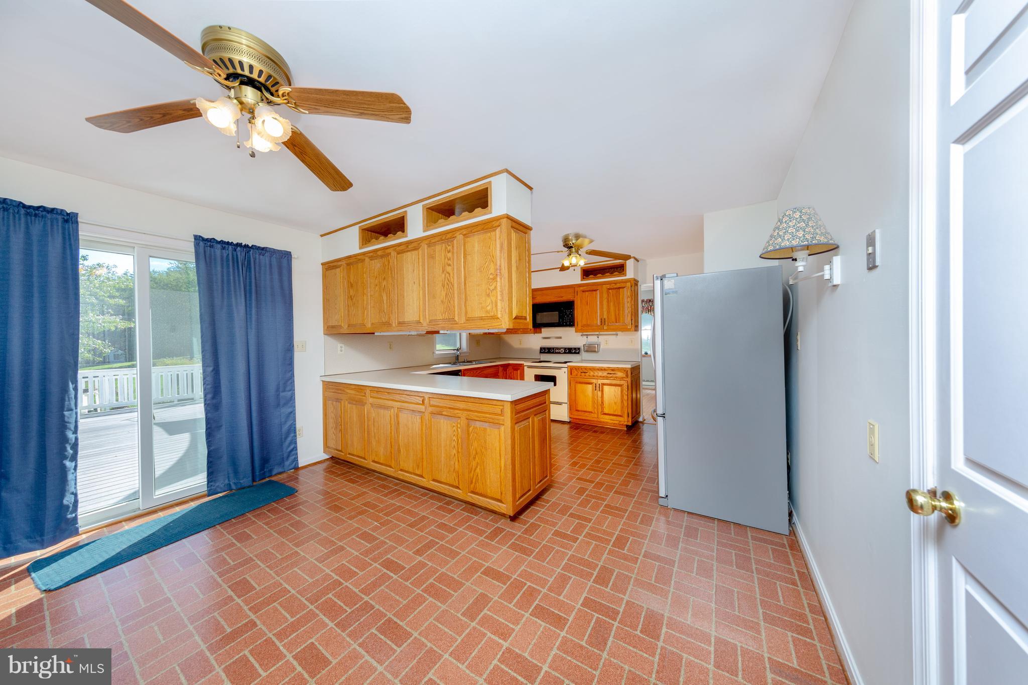 18257 Falls Road Hampstead, MD 21074 - Photo 4 of 49 a kitchen with a refrigerator and a stove