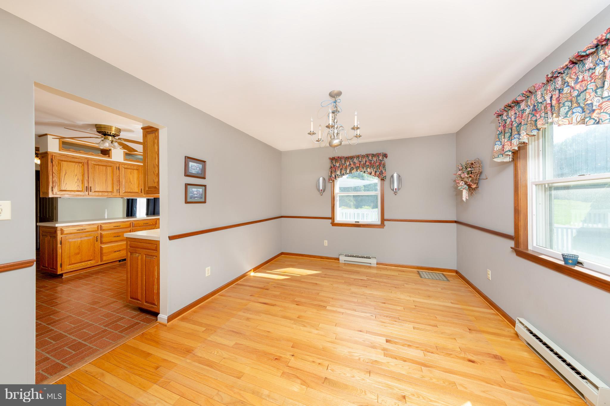 18257 Falls Road Hampstead, MD 21074 - Photo 5 of 49 a spacious bedroom with a large bed and a chandelier