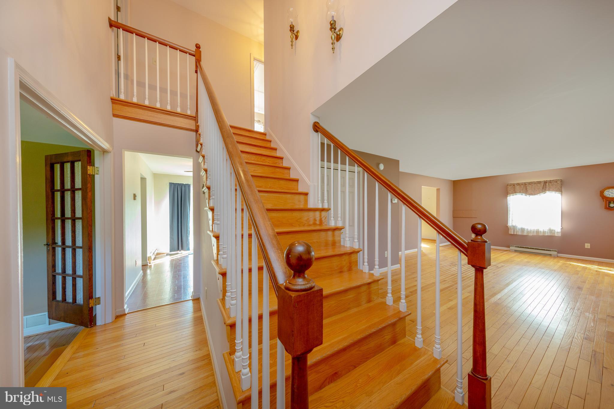 18257 Falls Road Hampstead, MD 21074 - Photo 6 of 49 a view of staircase with lots of frames on wall and wooden floor