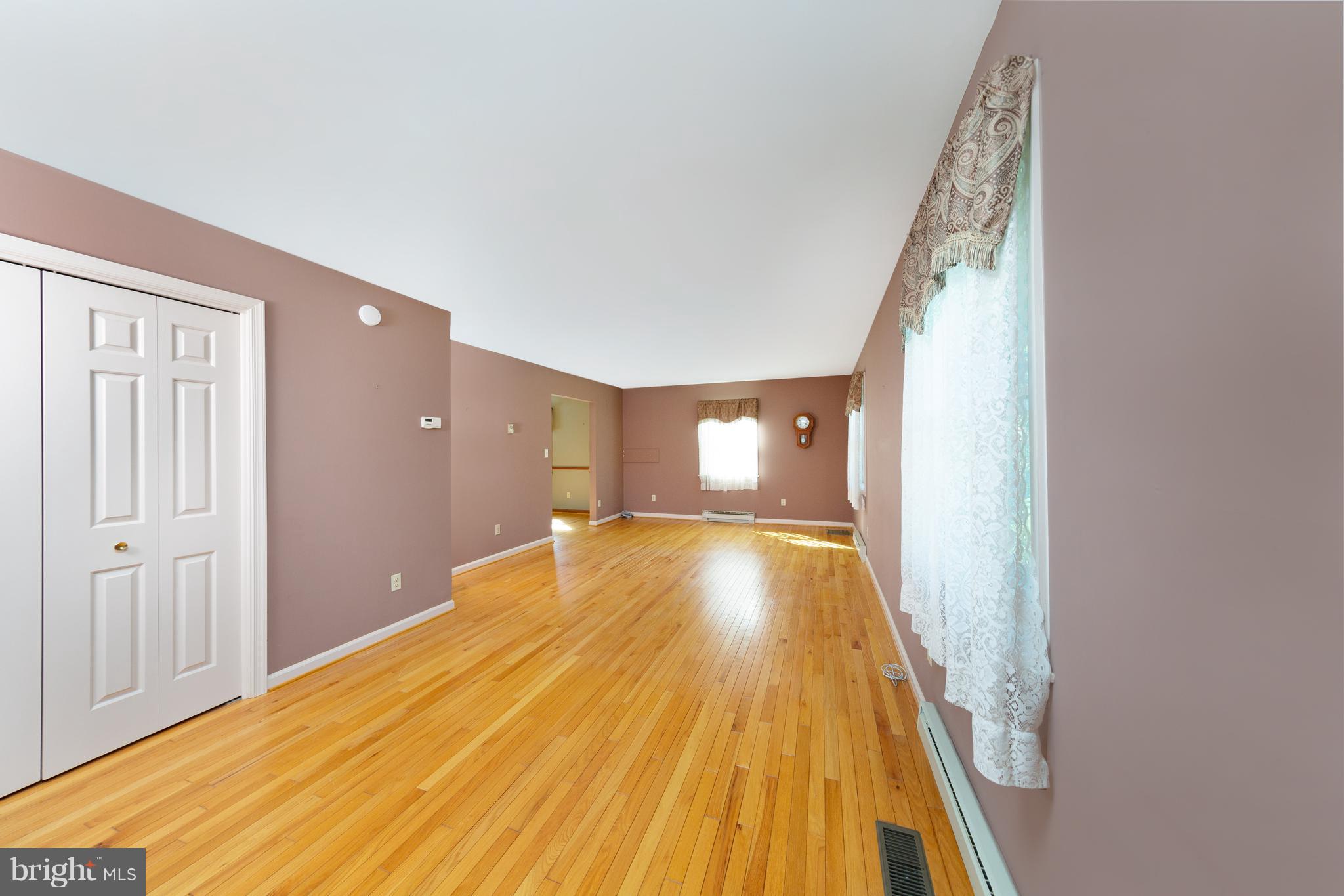 18257 Falls Road Hampstead, MD 21074 - Photo 9 of 49 a view of a room with wooden floor and staircase