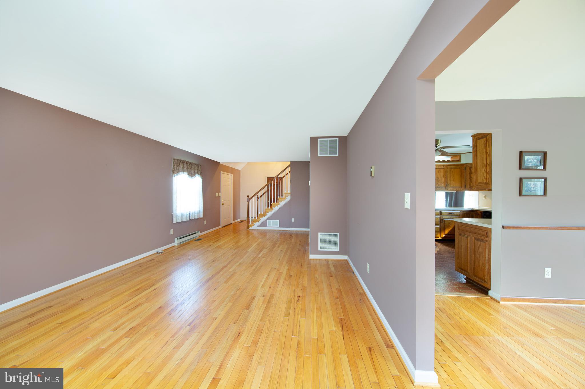 18257 Falls Road Hampstead, MD 21074 - Photo 10 of 49 a view of a living room with wooden floor and kitchen space
