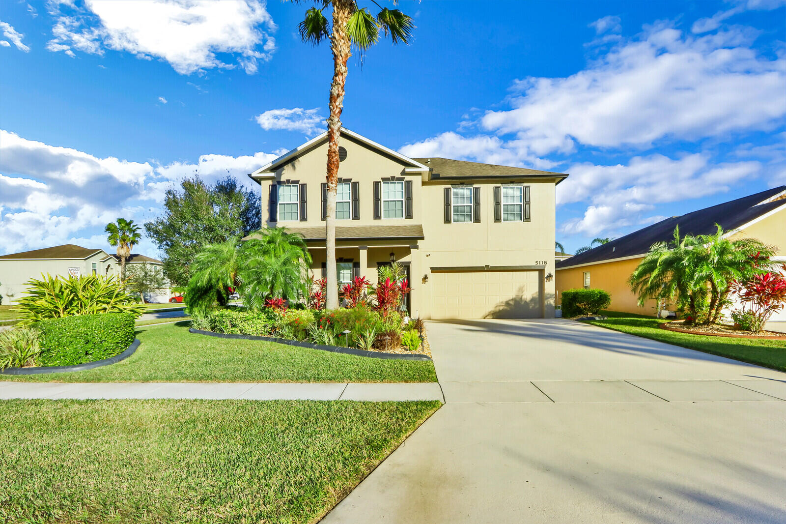 5118 Northwest Wisk Fern Circle Port St. Lucie, FL 34986 - Photo 1 of 34 a front view of a house with a yard