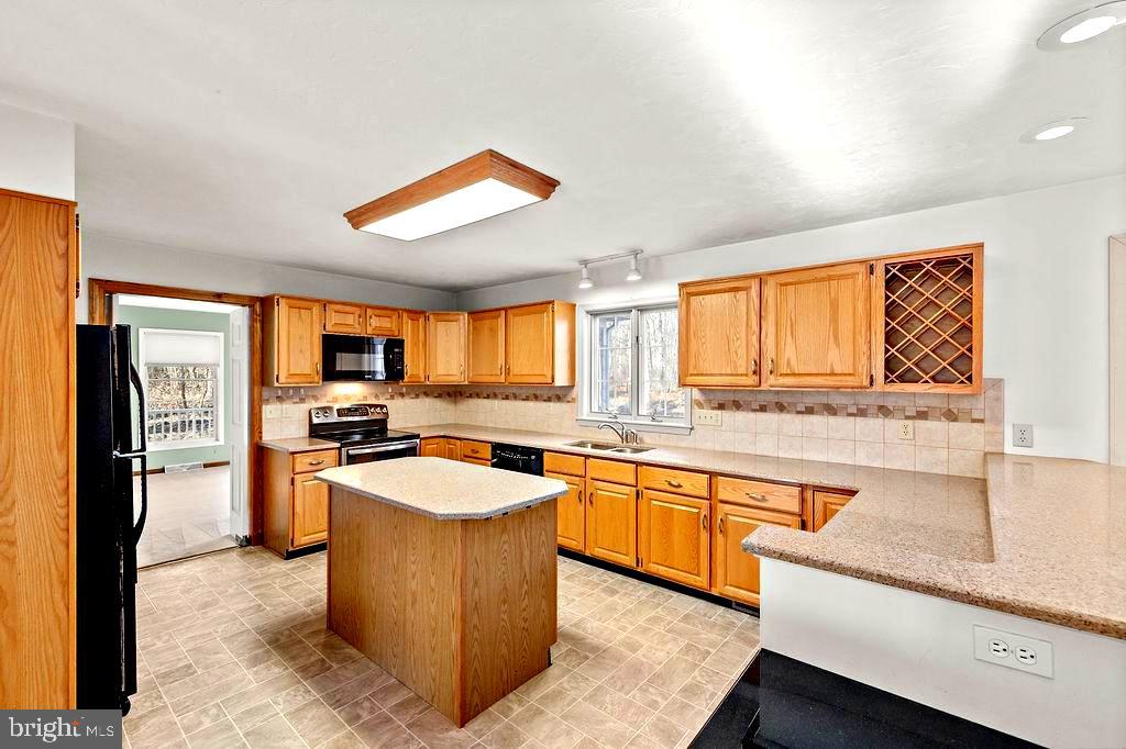 105 Round Top Lane Gettysburg, PA 17325 - Photo 15 of 50 a kitchen with stainless steel appliances granite countertop sink stove top oven and refrigerator