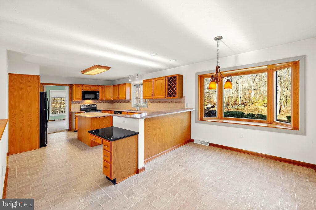 105 Round Top Lane Gettysburg, PA 17325 - Photo 16 of 50 a open kitchen with stainless steel appliances granite countertop a stove top oven a sink dishwasher and white cabinets next to a window