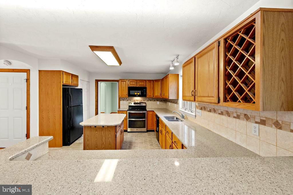 105 Round Top Lane Gettysburg, PA 17325 - Photo 17 of 50 a living room with stainless steel appliances kitchen island granite countertop furniture a rug and a large window