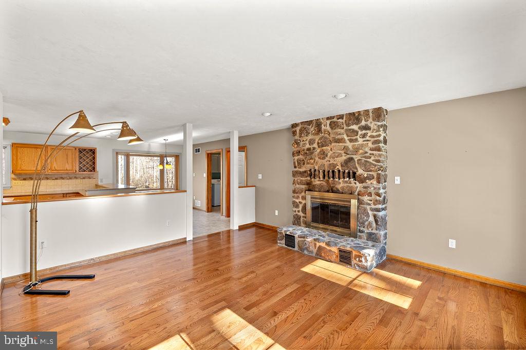 105 Round Top Lane Gettysburg, PA 17325 - Photo 27 of 50 a living room with furniture a fireplace and wooden floor