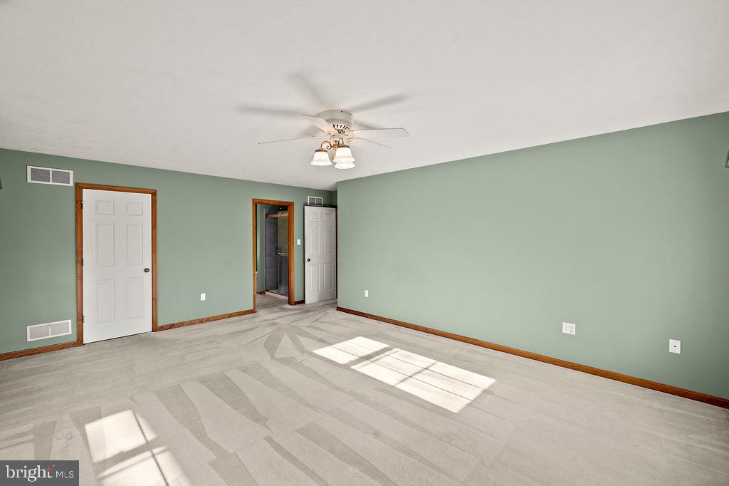 105 Round Top Lane Gettysburg, PA 17325 - Photo 30 of 50 an empty room with chandelier fan and windows